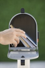 Man taking mail out of mailbox.