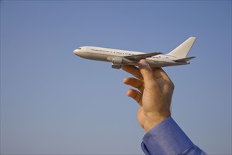 Man holding toy airplane.