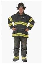 Male firefighter with hands on hips.