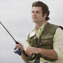 Close up of man fishing.