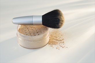 Powdered mineral makeup and brush .