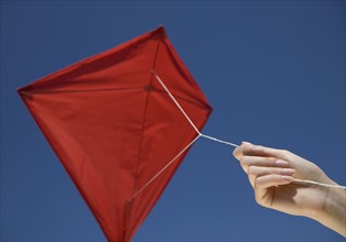 Woman flying kite.