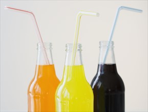 Glass soda bottles with straws.