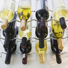 Assorted wine bottles on wine rack.