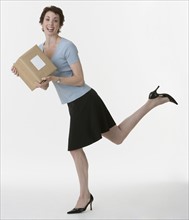 Businesswoman holding package.
