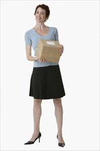 Businesswoman holding package.