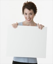 Businesswoman holding blank sign.