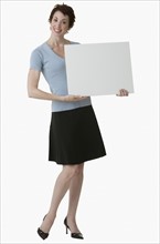 Businesswoman holding blank sign.