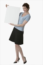 Businesswoman holding blank sign.