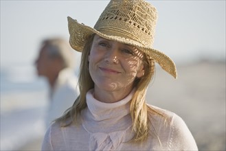 Woman wearing straw hat.