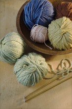 Assorted yarn and knitting needles.