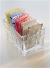Close up of sugar and sweetener packets.