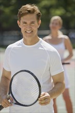 Couple on tennis court.