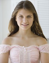Portrait of girl wearing off shoulder blouse.