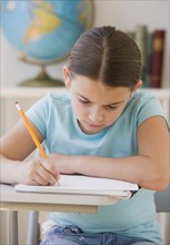 Girl writing in classroom.