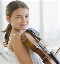Girl holding violin.