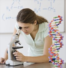 Girl looking through microscope.