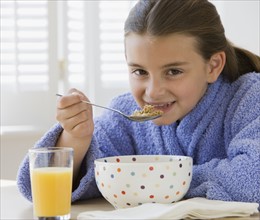 Girl eating breakfast cereal.