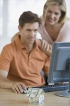 Couple looking at computer.