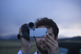 Man using video camera. Date : 2006