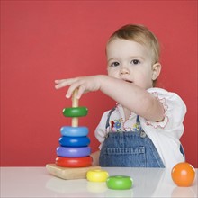 Female toddler playing with rings. Date : 2006