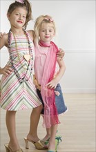 Two young sisters playing dress-up . Date : 2006