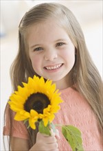 Portrait of girl holding sunflower. Date : 2006