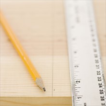 Close up of ruler and pencil on wood. Date : 2006