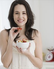 Portrait of woman eating fruit salad. Date : 2007