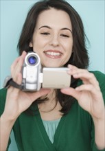 Portrait of woman using video camera. Date : 2007