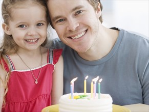 Father and daughter with birthday cake. Date : 2007