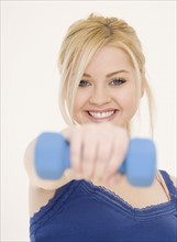 Woman holding dumbbell. Date : 2007