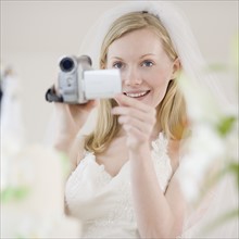 Bride using video camera. Date : 2007