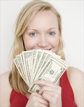 Woman holding fanned out money. Date : 2007