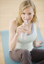 Woman drinking from water bottle. Date : 2007