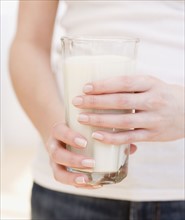 Woman holding glass of milk. Date : 2007