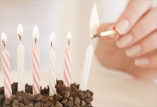 Woman lighting birthday candles. Date : 2007