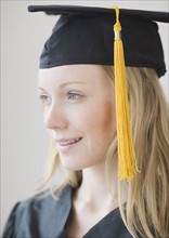 Woman wearing graduation cap and gown. Date : 2007