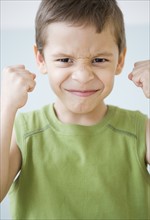Boy making a face and clenching fists. Date : 2007
