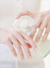 Woman applying hand lotion. Date : 2007