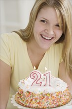 Portrait of woman with Twenty First birthday cake. Date : 2007