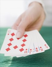 Woman holding straight flush playing cards. Date : 2007