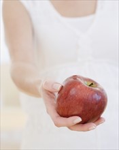 Woman holding apple. Date : 2007