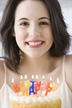 Portrait of woman next to birthday cake. Date : 2007