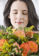 Woman smelling bouquet of flowers. Date : 2007