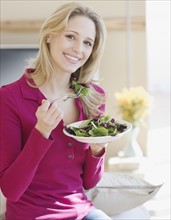 Portrait of woman eating salad. Date : 2007