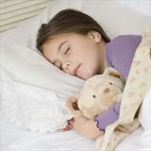 Close up of girl sleeping with teddy bear. Date : 2006