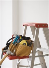 Tool belt on ladder shelf. Date : 2006