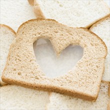 Slice of bread with heart in middle. Date : 2006