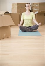 Woman meditating in new house. Date : 2006